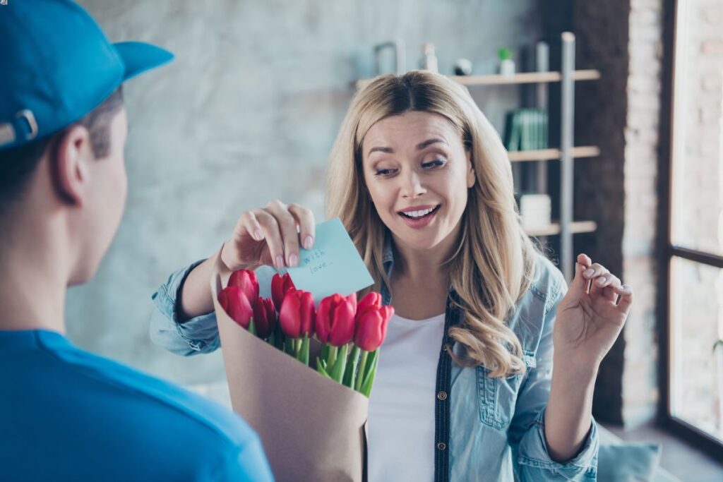 A woman getting flowers from online delivery